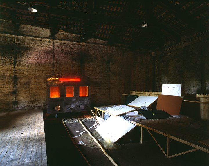 A model train platform with discarded artist canvases scattered across it